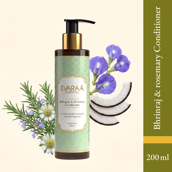 Bhringraj and Rosemary Conditioner bottle with a pump, surrounded by rosemary, blue flowers, and coconut slices.